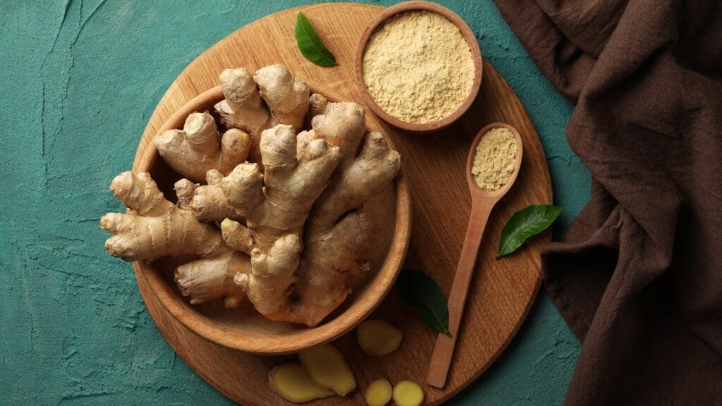 Board with Fresh Ginger on Green Background Manual of Health